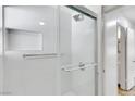 Updated bathroom shower with glass doors, built-in shelving and brushed nickel hardware at 703 Greenbriar Townhouse Way, Las Vegas, NV 89121