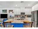 Spacious kitchen island with seating, granite countertops, stainless steel appliances, and white cabinetry at 7364 N Decatur Blvd # 4, Las Vegas, NV 89131