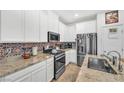 Well-equipped kitchen features stainless steel appliances, granite countertops, and stylish backsplash at 7364 N Decatur Blvd # 4, Las Vegas, NV 89131