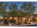 Lovely home with manicured landscaping, stone accents, a two-car garage and inviting walkway at 8429 Brackenfield Ave, Las Vegas, NV 89178