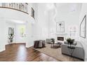 Bright, open living room with fireplace, tall ceilings, and modern decor provides a welcoming space at 8429 Brackenfield Ave, Las Vegas, NV 89178