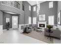 Bright, open living room with fireplace, tall ceilings, and modern decor provides a welcoming space at 8429 Brackenfield Ave, Las Vegas, NV 89178