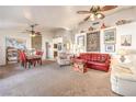 Spacious living room with ceiling fans, a carpeted floor, and lots of natural light at 8552 Desert Holly Dr, Las Vegas, NV 89134