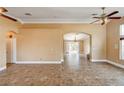 Spacious living room with tile flooring, neutral paint, and a view into the backyard at 8851 Quintane Ln, Las Vegas, NV 89123