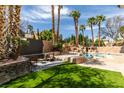 Resort-style pool with lush landscaping, rock features, and shaded seating area is perfect for outdoor living at 8913 Saint Pierre Dr, Las Vegas, NV 89134