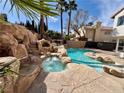 Backyard pool features a built-in spa and rocky landscape at 8913 Saint Pierre Dr, Las Vegas, NV 89134