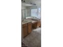 Bathroom featuring double sinks, tile flooring, a vanity, and a glass shower enclosure at 9162 Weeping Hollow Ave, Las Vegas, NV 89178