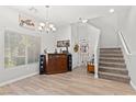 Inviting living area with lots of natural light, modern flooring and open staircase at 9494 Alma Ridge Ave, Las Vegas, NV 89178