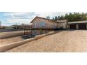 Home with stone accents has a two-car garage and a back yard patio at 9865 Penny Ln, Las Vegas, NV 89178