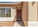 Close-up of the front door with a textured wall and decorative trim at 1016 Echo Beach Ave, North Las Vegas, NV 89086