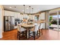 Bright, modern kitchen with granite countertops, stainless steel appliances, and a center island with seating at 12245 Olivetta Ct, Las Vegas, NV 89138