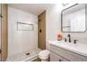 A modern bathroom features a walk-in shower with a glass partition, clean lines and new fixtures at 1642 E St, Las Vegas, NV 89106