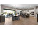 Open-concept kitchen with stainless appliances, large island, and seamless flow to the outdoor living area at 193 Elder View Dr, Las Vegas, NV 89138