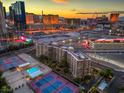 Beautiful aerial view showcasing the city skyline, community pool, and tennis courts at 205 E Harmon Ave # 1007, Las Vegas, NV 89169