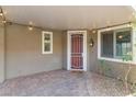 Inviting front porch with brick flooring, decorative lighting, and charming 'Home Sweet Home' welcome mat at 2091 Hunt Woods Ct, Laughlin, NV 89029