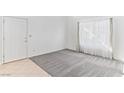 Bright, airy living room featuring carpet and tile flooring and white walls at 2146 High Dunes Ln, Laughlin, NV 89029