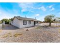 Side view of a home with a gravel yard and black trimmed windows at 2716 Saber Dr, North Las Vegas, NV 89032