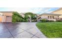 Beautiful exterior with a stamped concrete driveway, 3-car garage and lush ivy at 3041 Hammerwood Dr, Las Vegas, NV 89135