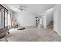 Bright living room with tile flooring, staircase and a view into the front entrance at 367 Lander Dr, Henderson, NV 89074