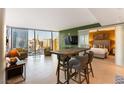 Open living space with a bar table, chairs, and views of the Las Vegas skyline at 3722 Las Vegas Blvd # 1908, Las Vegas, NV 89158