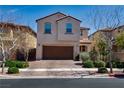 Two-story stucco house with brick driveway and two-car garage at 386 Espressivo St, Henderson, NV 89011