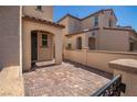 Courtyard entrance to home with covered walkway and brick pavers at 386 Espressivo St, Henderson, NV 89011