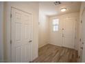 Hallway with wood tile floors, white doors, and natural light at 386 Espressivo St, Henderson, NV 89011