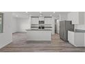 Modern kitchen featuring white cabinets, stainless steel appliances, and a center island at 4253 Gold Desert St, North Las Vegas, NV 89032
