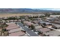 Aerial view of a residential neighborhood with mountain views in the distance and well maintained landscaping at 4429 S Glory Vine Ln, Pahrump, NV 89061