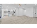 Open-concept layout showcasing the bright living room and updated kitchen with new floors at 4629 Alta Dr, Las Vegas, NV 89107
