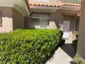 Inviting entrance with manicured shrubs and a concrete walkway leading to a bright front door at 5041 Mount Pleasant Ln, Las Vegas, NV 89113