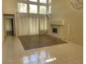 Spacious living room featuring a fireplace, large windows, and neutral colors, perfect for relaxing at 5041 Mount Pleasant Ln, Las Vegas, NV 89113