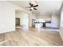 Open-concept kitchen with stainless steel appliances and an island, flowing into the living area at 5829 Aqua Verde St, North Las Vegas, NV 89031