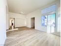 Spacious living room boasts wood flooring, natural light, and a neutral color palette at 5829 Aqua Verde St, North Las Vegas, NV 89031