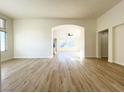Bright, open living area features hardwood floors and arched doorways to connecting rooms at 5829 Aqua Verde St, North Las Vegas, NV 89031