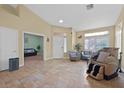 Spacious living room with tile floors and comfortable seating area with natural light at 5835 Farmhouse Ct, Las Vegas, NV 89141