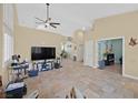 Open-concept living room with tile flooring, neutral walls, and modern ceiling fan at 5835 Farmhouse Ct, Las Vegas, NV 89141