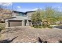 Charming two-story home with a three-car garage and a beautiful brick driveway at 6491 Wild Blue Ct, Las Vegas, NV 89135