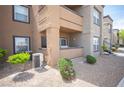 Exterior of an apartment building with well-kept landscaping, featuring a small patio at 6650 W Warm Springs Rd # 1079, Las Vegas, NV 89118