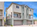 Modern two-story townhome featuring a private balcony and a two-car garage on a sunny day at 6821 Prairie Pearl St, Las Vegas, NV 89148