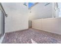 Private backyard featuring a paved patio area with gated access, perfect for outdoor dining and relaxation at 7017 Magenta Moon St, North Las Vegas, NV 89086