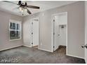 A well-lit bedroom features a ceiling fan, a window, and a doorway to a walk-in closet at 9050 W Tropicana Ave # 1009, Las Vegas, NV 89147