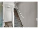 Staircase with modern design, white railings and gray stairs leads to the upper level of the home at 9050 W Tropicana Ave # 1009, Las Vegas, NV 89147