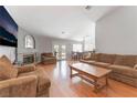 Spacious living room featuring wood floors, fireplace, neutral walls, and access to the backyard at 1010 Armillaria St, Henderson, NV 89011