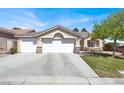 Lovely home with a three-car garage, well-maintained lawn, mature landscaping and beautiful desert landscape at 10200 Clark Wooldridge Ct, Las Vegas, NV 89129