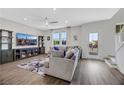 Spacious living room featuring a comfortable sofa, media center, and bright natural light from the windows at 1180 Solano Hills Ct, Henderson, NV 89002