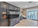 Cozy living area with large media center, tile floors, and access to the backyard patio at 14 Page St, Las Vegas, NV 89110
