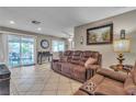 Comfortable living room with tile floors, recessed lighting, and sliding glass doors to the patio at 14 Page St, Las Vegas, NV 89110