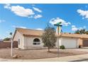 Charming single-story home featuring a well-maintained front yard, two-car garage, and tiled roof at 1403 Bareback Ct, Henderson, NV 89014