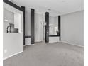 Spacious living room featuring gray carpet, modern decor, and neutral wall colors at 1403 Bareback Ct, Henderson, NV 89014